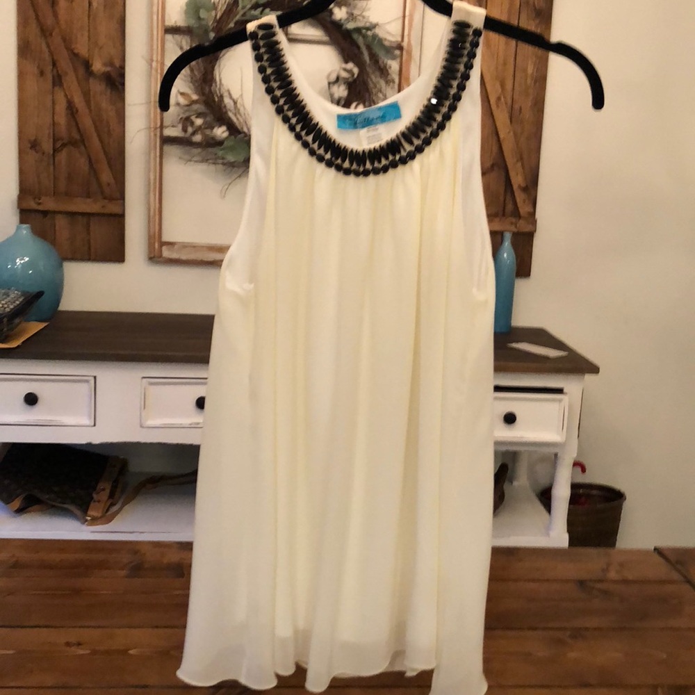 Ivory colored flowy top with black beading